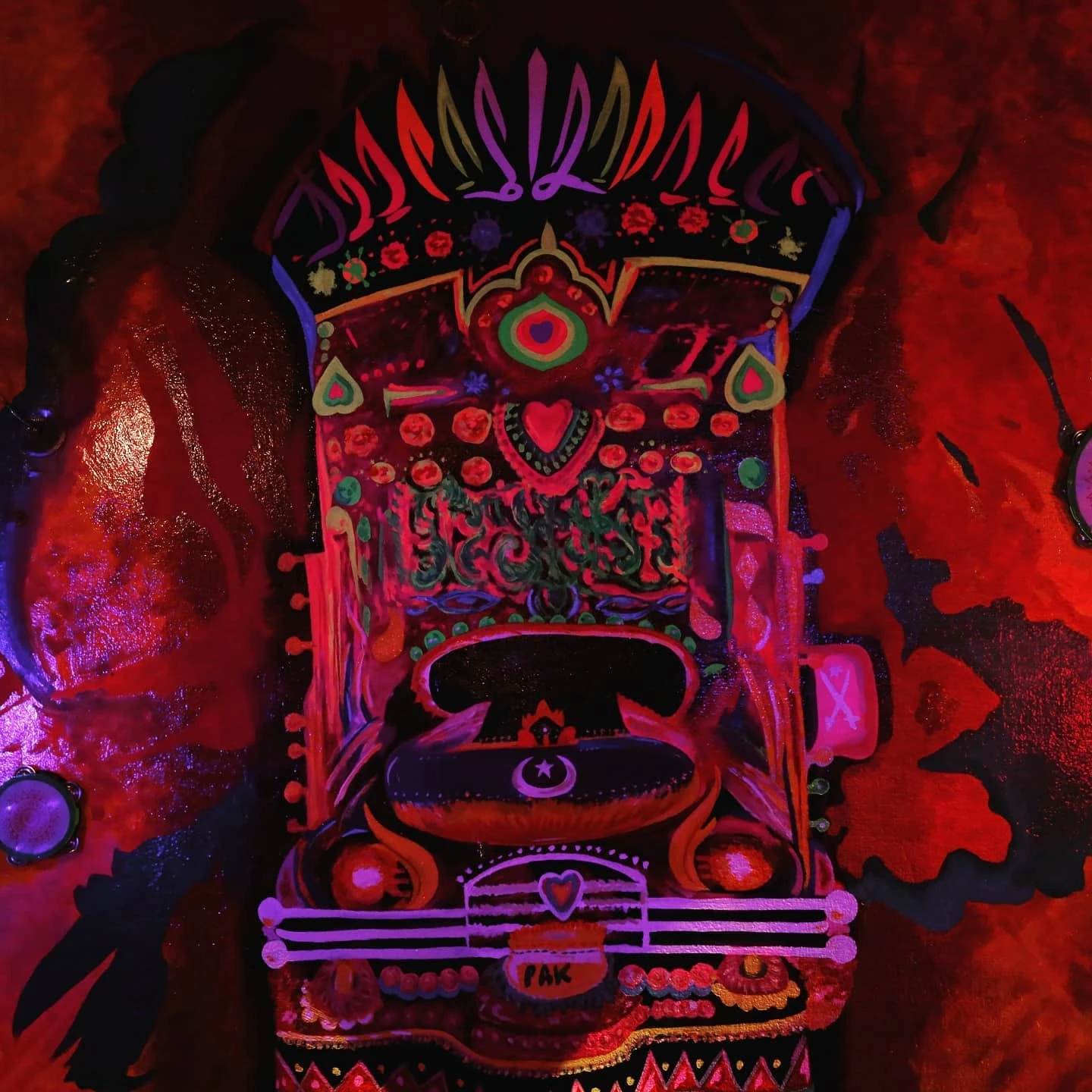 Pakistani truck-art mural under blacklight